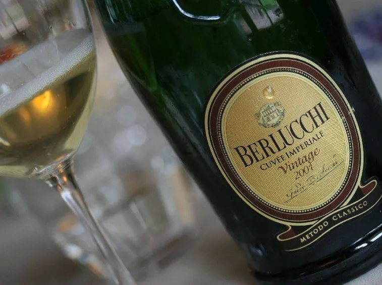 Bicchiere e bottiglia di berlucchi cuvee imperiale